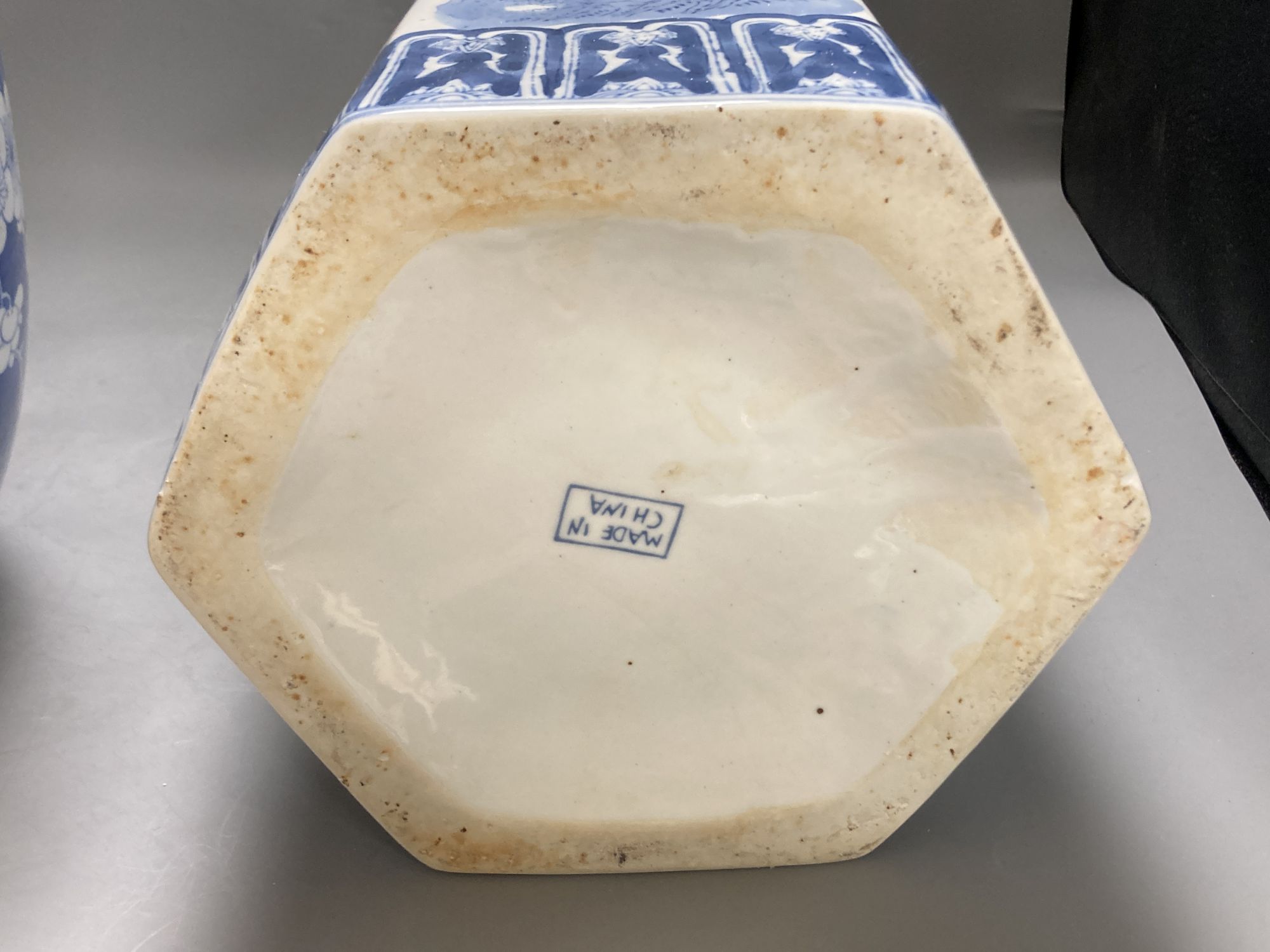 A large 19th century Chinese blue and white prunus jar and cover, height 35cm, and a late 20th century Chinese blue and white stick sta